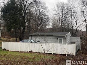 Lemont Furnace house for rent - A house with a white fence and a car parked in front.