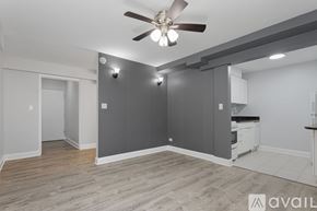 Chicago apartment for rent - A room with a ceiling fan and light fixture.