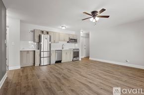 Chicago apartment for rent - A spacious kitchen with wooden floors and a ceiling fan.