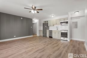 Chicago apartment for rent - A spacious kitchen with wooden flooring and modern appliances.