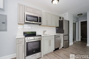 Chicago apartment for rent - A kitchen with a stove, oven, microwave, and refrigerator.