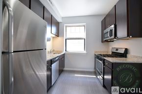 Chicago apartment for rent - A modern kitchen with stainless steel appliances and a window.