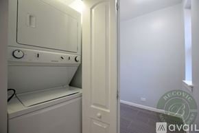 Chicago apartment for rent - A white washing machine is in a small room with a door.