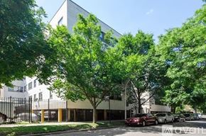 Chicago apartment for rent - A modern building with a parking lot in front.