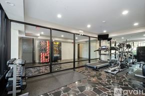 Chicago apartment for rent - A gym with a row of dumbbells on the left and a row of treadmills on the right.