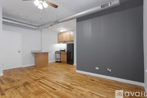 Chicago apartment for rent - A room with wooden floors and a ceiling fan.