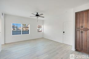 Hanford Ca apartment for rent - A room with a ceiling fan and a large window with a view of a body of water.