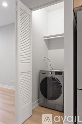 Chicago apartment for rent - A washing machine is in a small room.