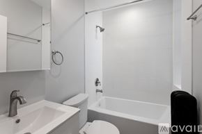Chicago apartment for rent - A white bathroom with a sink, toilet, and bathtub.