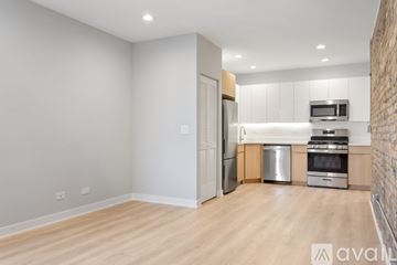 Chicago apartment for rent - A kitchen with a refrigerator, microwave, oven, and dishwasher.
