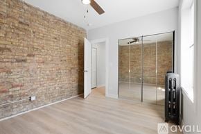 Chicago apartment for rent - A room with a brick wall and a glass door.