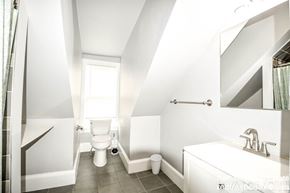 Boston apartment for rent - A white bathroom with a toilet, sink, and bathtub.