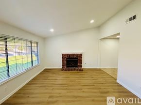 Lancaster house for rent - A spacious room with a fireplace and wooden flooring.