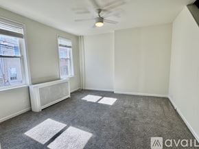 Philadelphia house for rent - A room with a carpet floor, a window, and a ceiling fan.