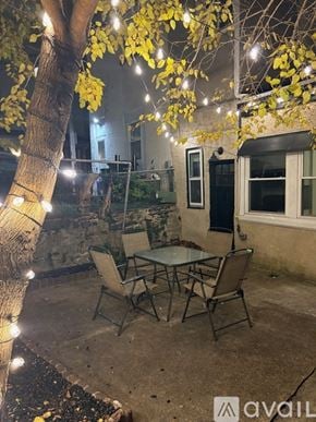 Philadelphia house for rent - A bedroom with a bed, nightstand, and a bench.