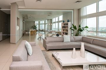 Miami condo for rent - A modern living room with a large sofa set and a coffee table.