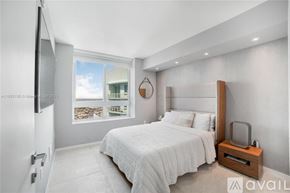 Miami condo for rent - A bedroom with a large bed and a television on the wall.