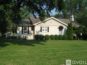 St. Louis house for rent - A house with a white fence and green lawn.