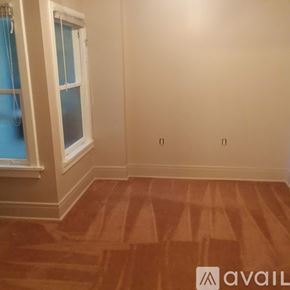 Vassar apartment for rent - A room with a window and wooden flooring.