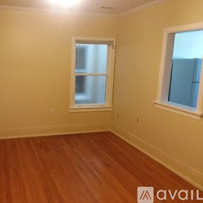 Vassar apartment for rent - A room with wooden floors and two windows.