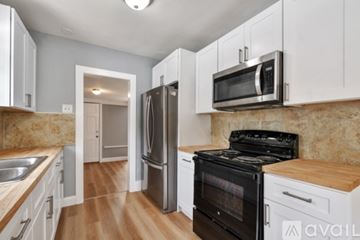 St. Petersburg townhouse for rent - A kitchen with a black oven and white cabinets.