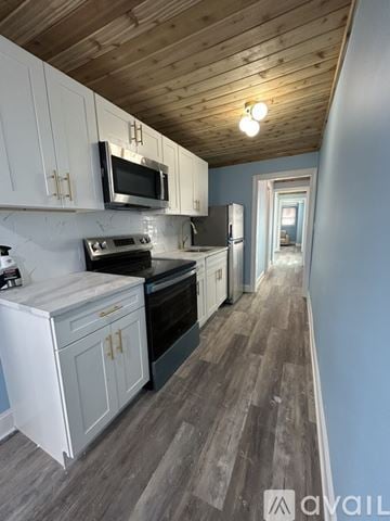 Seaside Heights apartment for rent - A kitchen with a white refrigerator and a wooden ceiling.