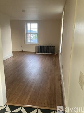Myersville apartment for rent - A room with wooden floors and a window with a view of the street outside.