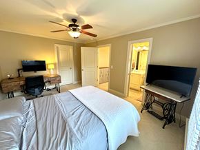 Greer house for rent - A bedroom with a large bed and a flat screen TV.