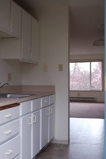 Federal Way apartment for rent - A kitchen with white cabinets and a sink.