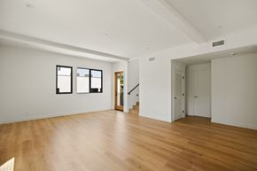 Los Angeles house for rent - A room with wooden floors and white walls.