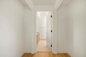 Los Angeles house for rent - A hallway with a white door leading to another room.