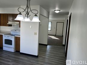 Pekin apartment for rent - A modern kitchen with a white refrigerator and wooden cabinets.