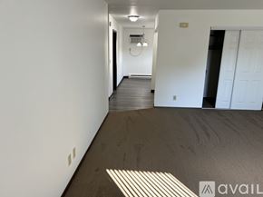Pekin apartment for rent - A long hallway with a white door on the right and a light on the ceiling.