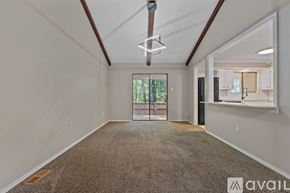 Maumelle house for rent - A spacious room with a carpeted floor and a ceiling fan.