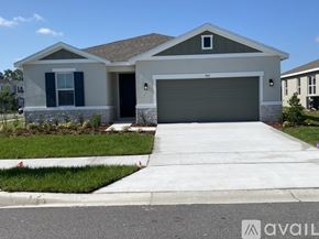 Haines City house for rent - A modern house with a garage door and a driveway.