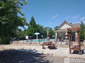 Boiling Springs house for rent - A pool area with a table and chairs and a house in the background.