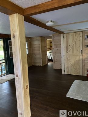 Somerset house for rent - A room with wooden floors and a white ceiling with a light fixture.