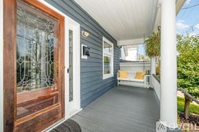Cincinnati house for rent - A porch with a white railing and a wooden door.