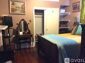 New Orleans house for rent - A bedroom with a bed, desk, and chair.