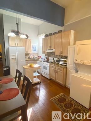 New Orleans house for rent - A kitchen with wooden cabinets and white appliances.