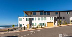 Manhattan Beach condo for rent - A modern building with a clear blue sky in the background.