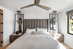 Manhattan Beach condo for rent - A bedroom with a large bed and a ceiling fan.