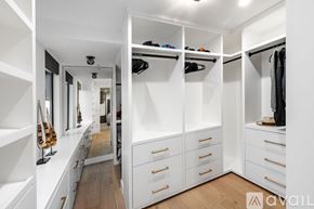 Manhattan Beach condo for rent - A spacious walk-in closet with white shelving and drawers.