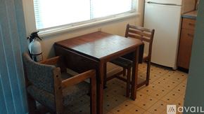 Berea apartment for rent - A wooden dining table with two chairs in front of a window.