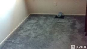 Berea apartment for rent - A room with a dirty floor and a blue object on it.