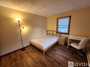 Quincy apartment for rent - A bedroom with a bed, chair, and desk.