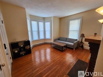 Quincy apartment for rent - A living room with a grey couch and wooden floors.