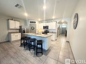 Davenport house for rent - A kitchen with a bar area and a fridge.