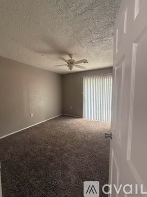 Bryan apartment for rent - A room with a ceiling fan and carpeted floor.