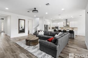 Winter Garden house for rent - A modern kitchen with a large island and a refrigerator on the left.